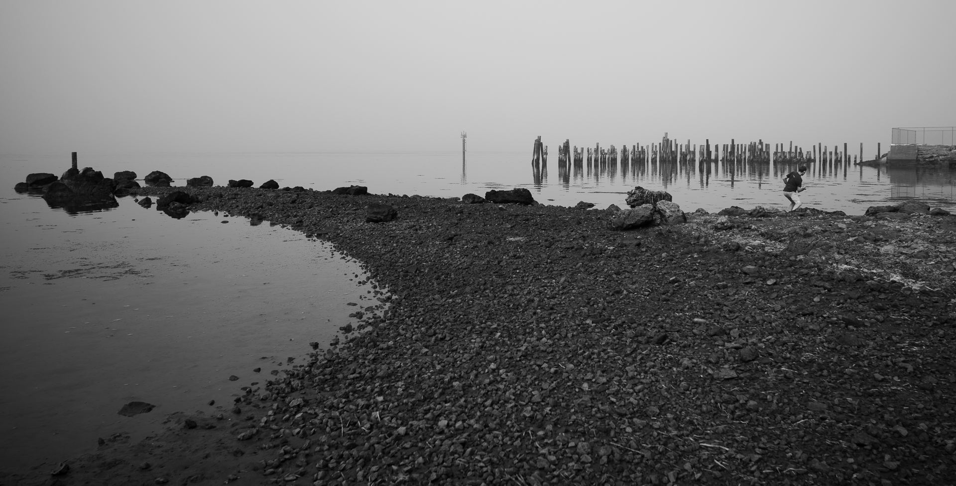 Skipping stones A boy skipping stones in the fog